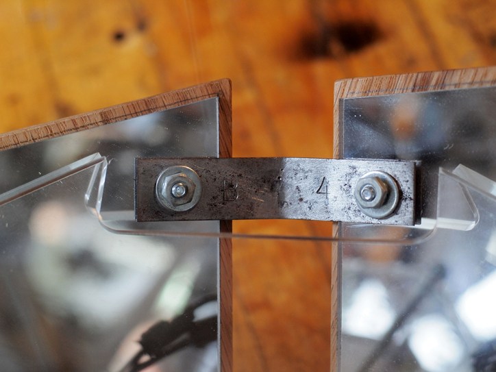 Hand make brackets from reclaimed metal salvaged from an older interactive artwork. Hand-stamped with cataloging numbers for proper placement.