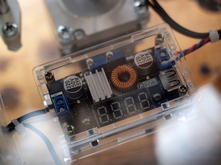 This buck converter splits the 12V from the power supply to 5V that charge the LED lights.