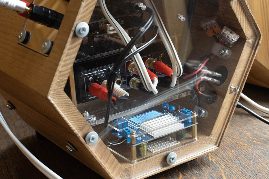 Audio wires, Arduino, buck converter, and the back of an audio amp.