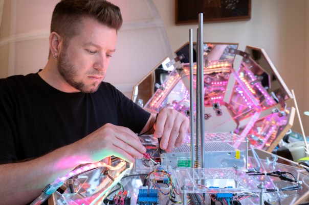 Daric Gill in his studio working on an interactive light sculpture
